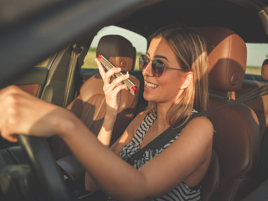 a woman talking on the phone while driving